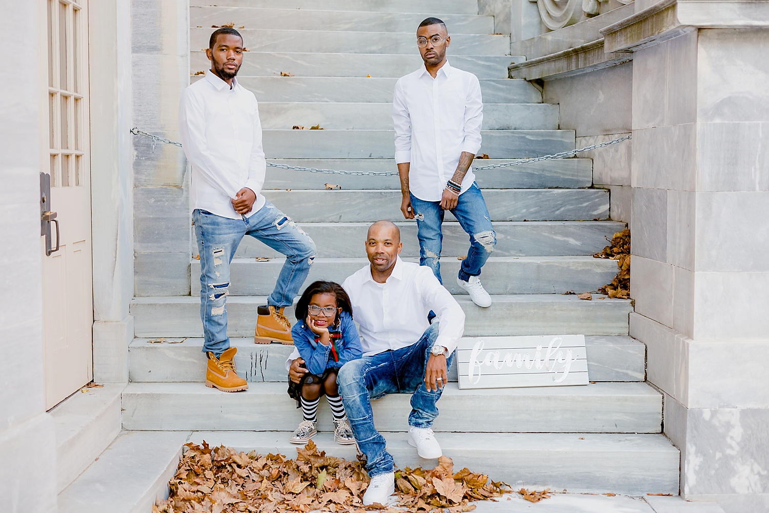father poses with his children for family portrait
