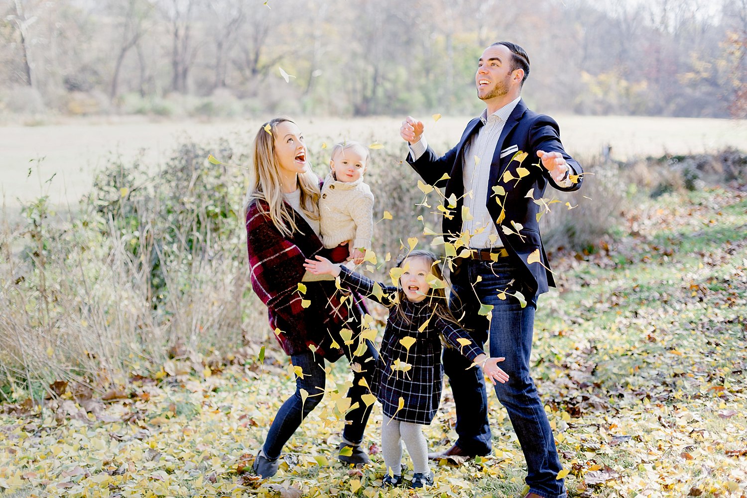 family of four playing in leaves at knox hill estate in PA