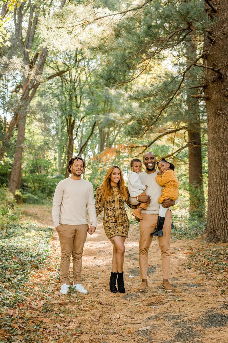 Family of five pose for portraits by Ann Blake Photography in Awbury Arboretum